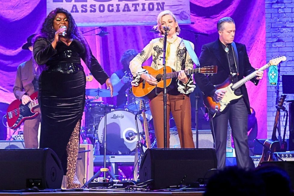 Americana music performers singing and playing guitar.