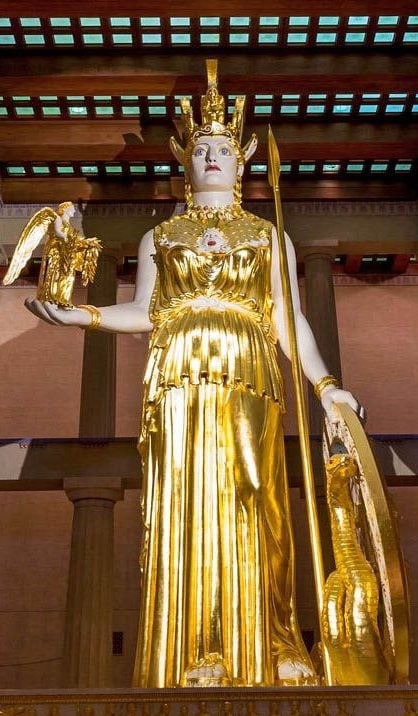 A tall, golden statue of Athena