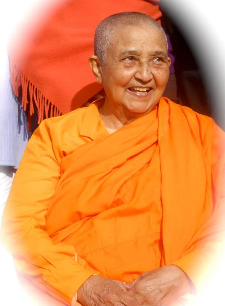 Photograph of Ven. Dr. Bhikkhuni Kusuma, smiling and wearing an orange robe.