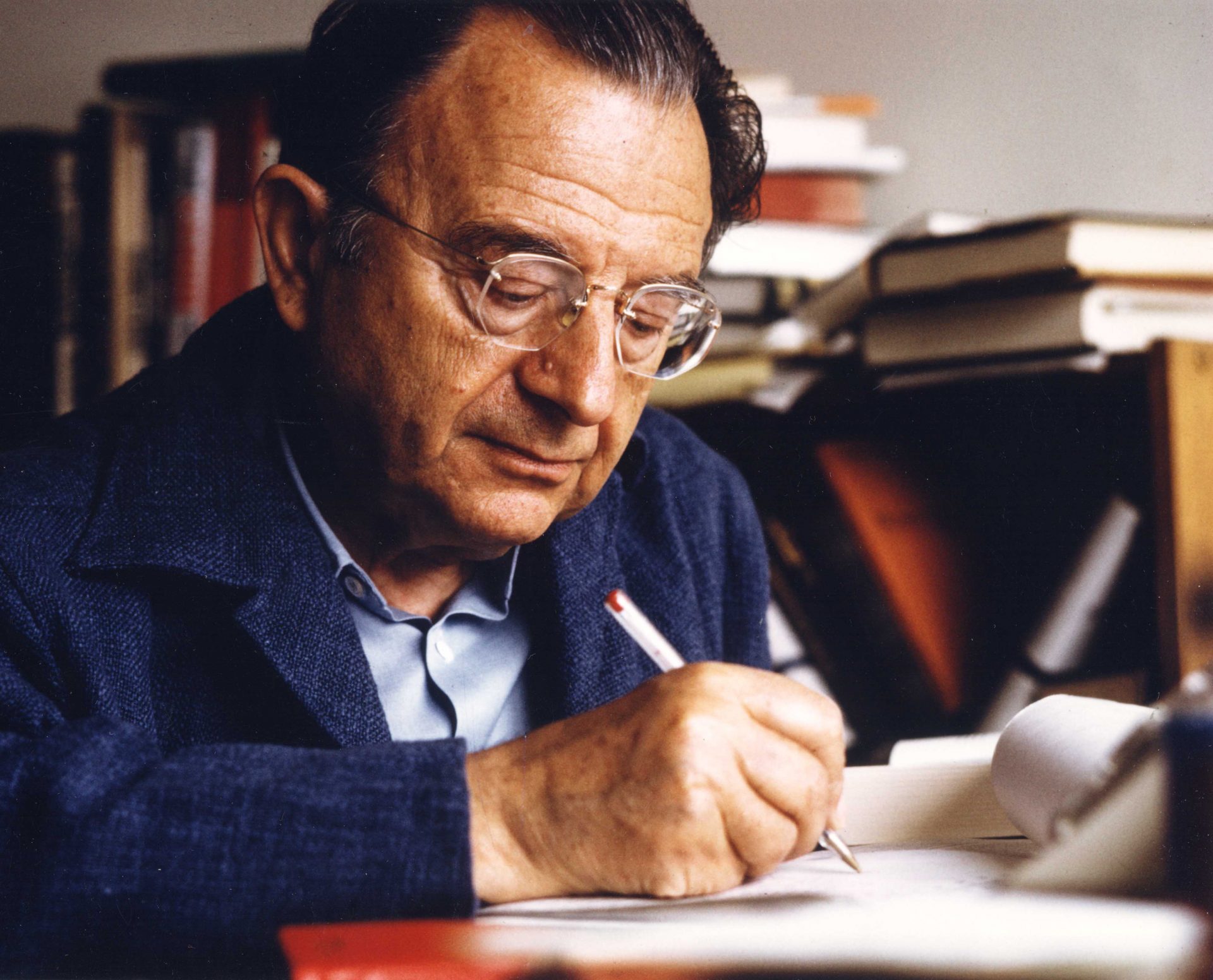 Erich Fromm writing at a desk