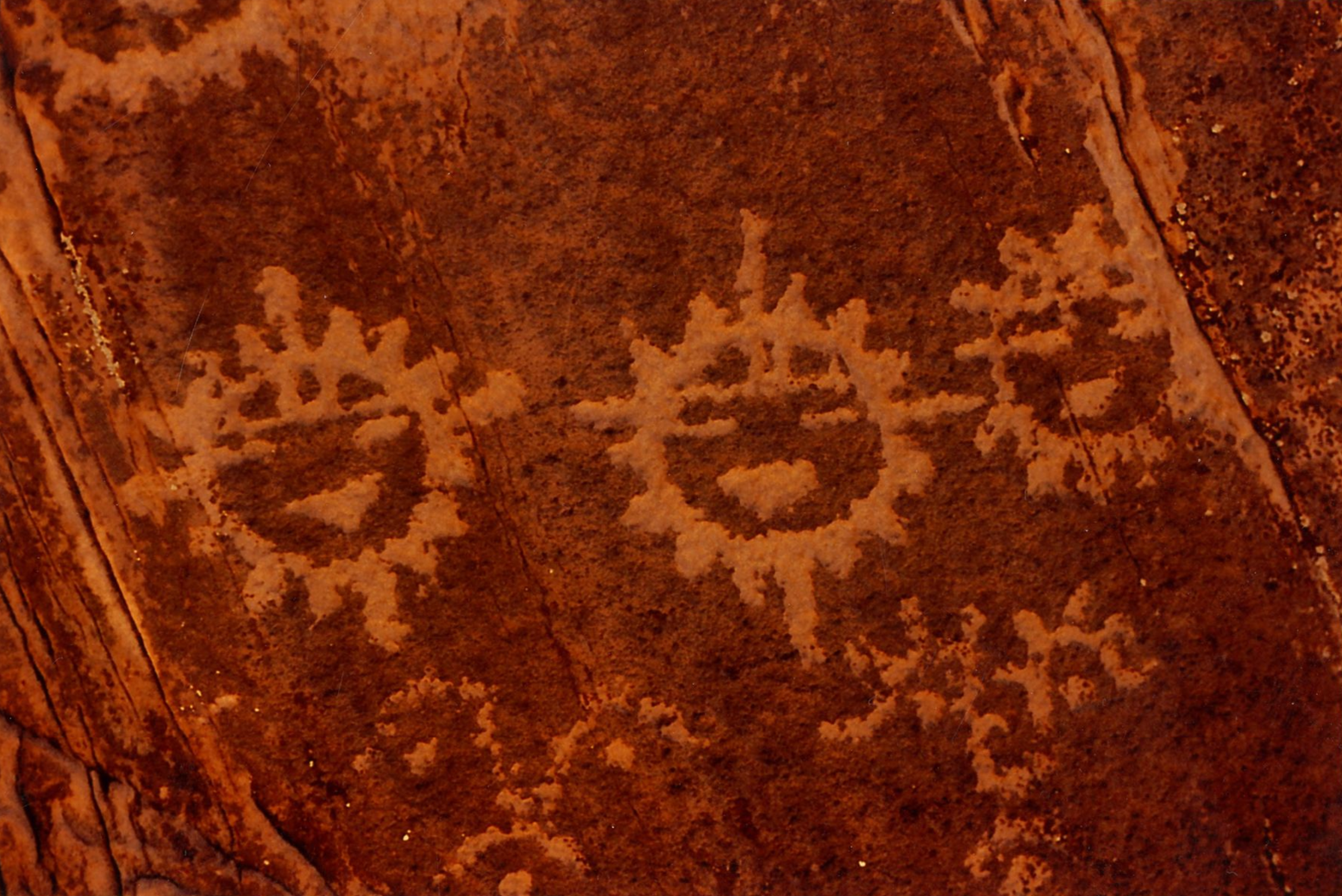 Hopi petroglyph showing three figures representing the Sun Kachina, Tawa deity