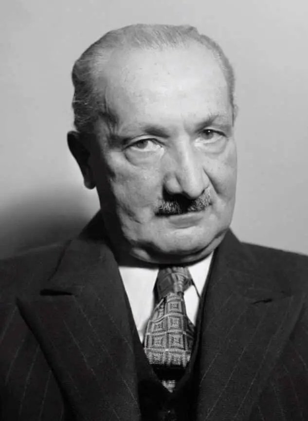 A black and white portrait of Martin Heidegger.