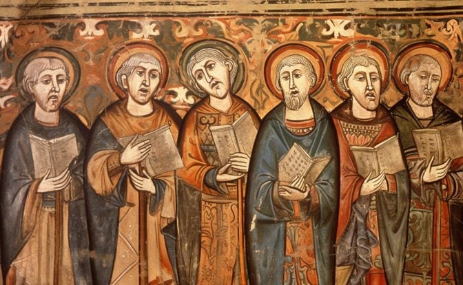 A fresco of a medieval choir with saintly halos around their heads