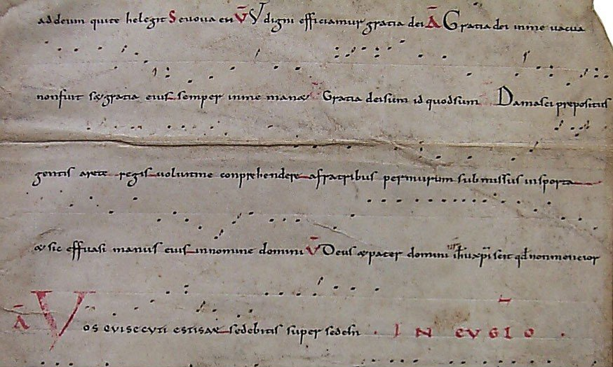 A document showing neumes grouped on a horizontal red line that represents the pitch F
