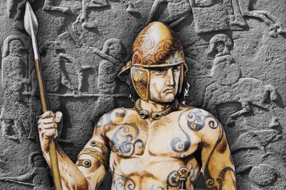 A Pictish warrior with a spear and helmet, adorned with tattoos, standing in front of a stone wall with carvings.
