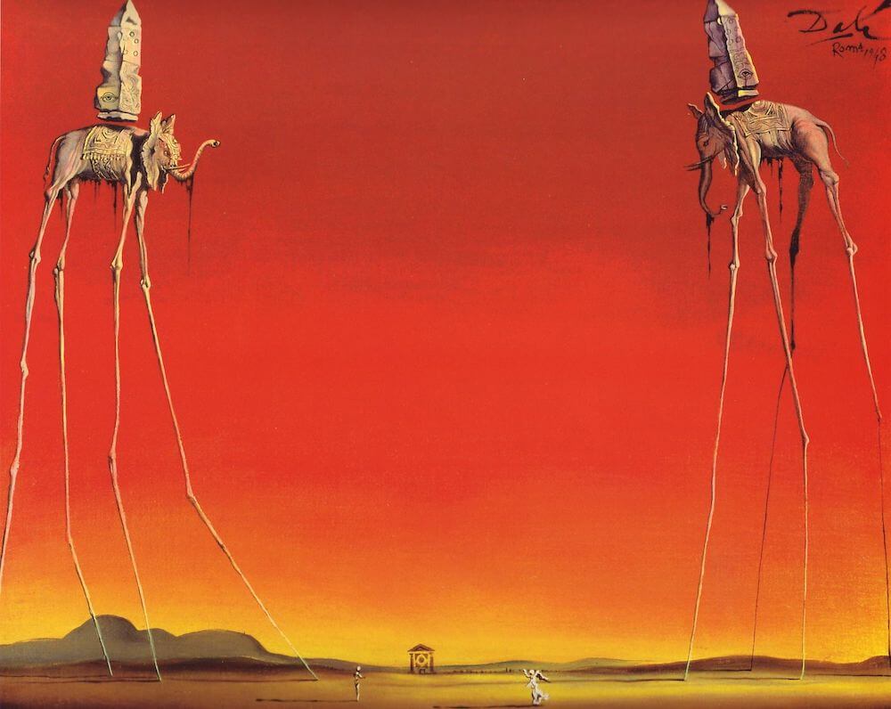 A surreal painting by Salvador Dali titled “The Elephants”. The painting shows two elephants with elongated legs and bodies, carrying obelisks on their backs. The elephants are walking on stilts, their legs extending down to the ground. The background is a red-orange sky with a horizon line and a small house in the distance.