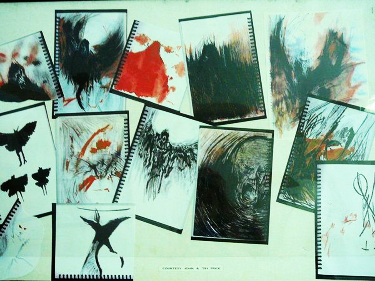 An abstract art piece consisting of multiple small paintings or sketches in black and white with some red and orange accents, arranged in a collage-like manner on a light green background.