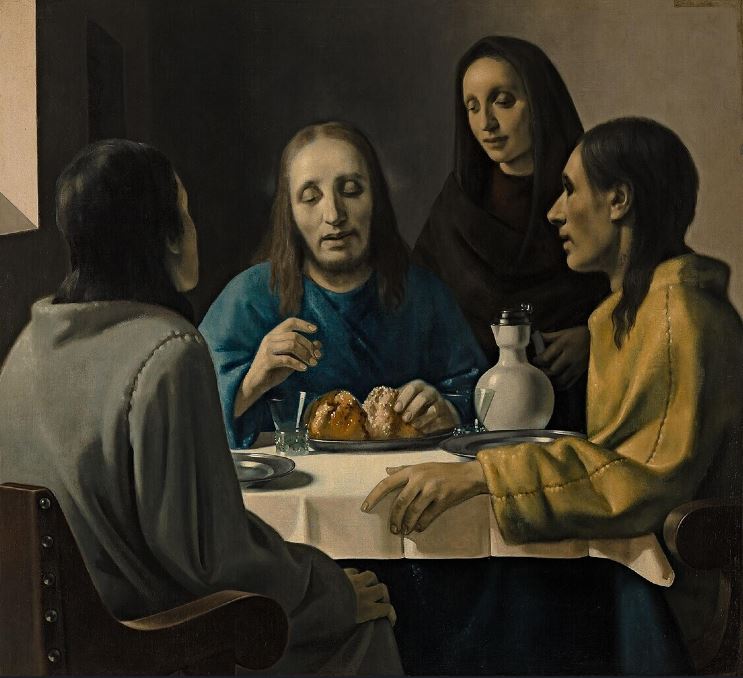 The image is a painting of a group of people sitting at a table with a plate of food in front of them. The people are dressed in traditional ancient clothing, with the person in the center wearing a blue robe. They are all looking at the man in the center. The man in the center is reaching out to take a piece of bread. The background of the image is a plain, light-colored wall. There is light coming through a window to the side of the room.