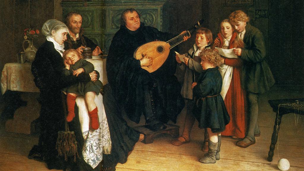 A painting of Martin Luther surrounded by his family, playing a lute and his children singing.