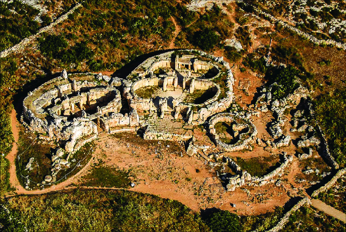 Aerial view of the Mnajdra complex with the small trefoil temple at the right, the north temple at the top, and the south temple in the bottom-left.
