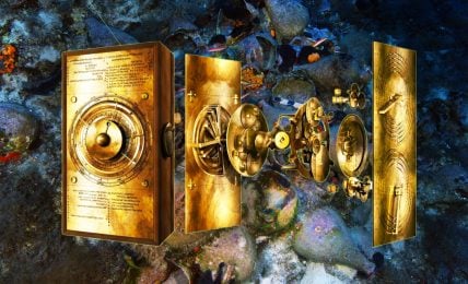 Photo realistic image of a computerized breakdown of the Antikythera Mechanism – golden mechanical device with gears and dials. In the background, an underwater photo of ancient amphora pots covered in coral and sea life, with striped fish swimming near them.