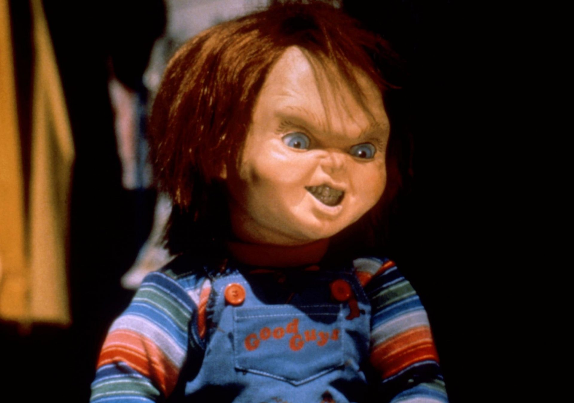 A creepy doll, Chucky, scowling