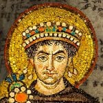 A collage of a mosaic of Justinian I wearing a crown overlaid on a manuscript page.