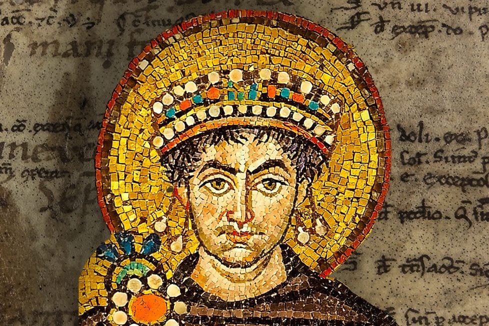 A collage of a mosaic of Justinian I wearing a crown overlaid on a manuscript page.