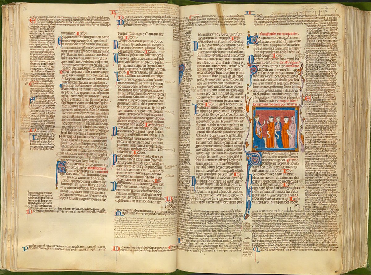 An open medieval manuscript excerpt from “Codex Justiniani I-IX” with Gothic text and a small illustration of three figures in a blue and gold frame.