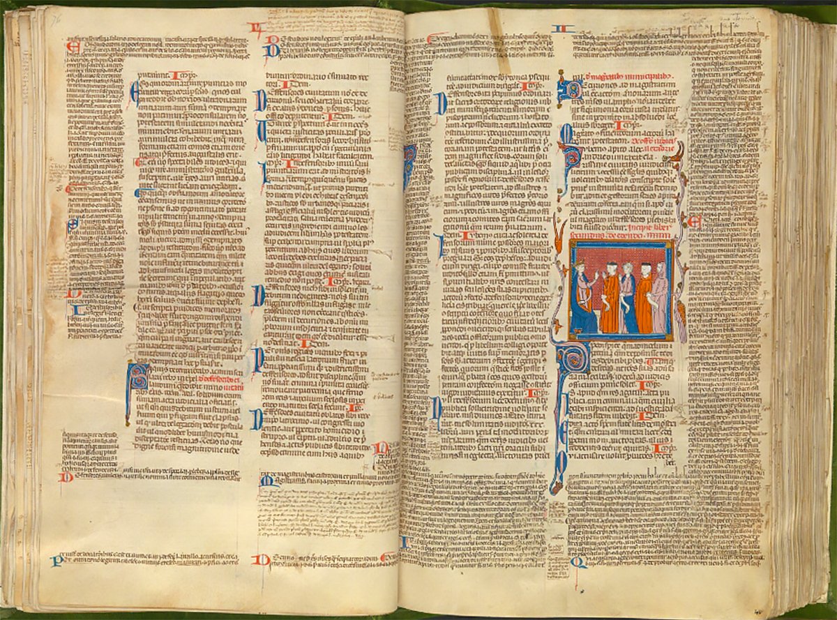 An open medieval manuscript excerpt from “Codex Justiniani I-IX” with Gothic text and a small illustration of three figures in a blue and gold frame.