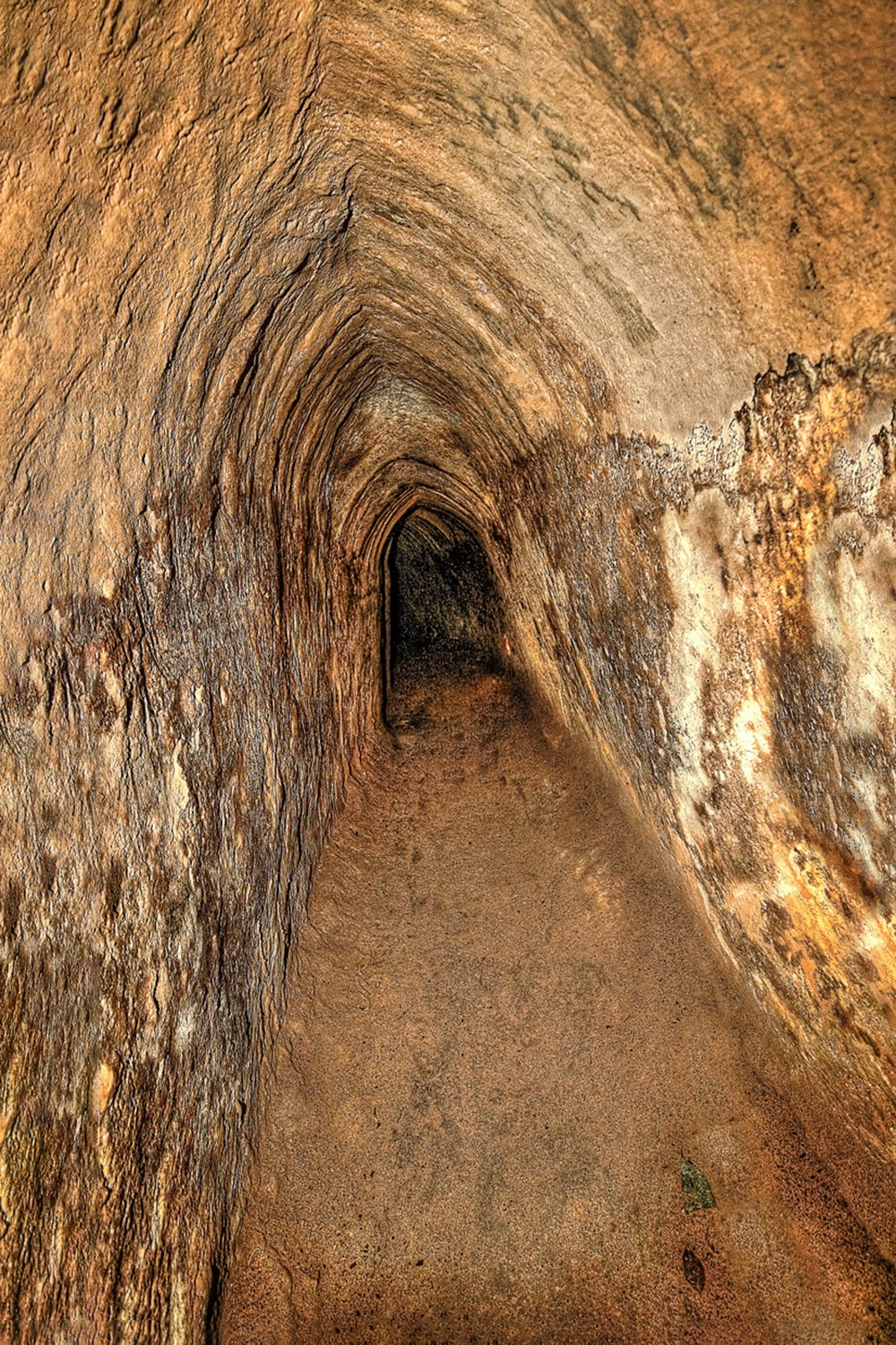 A photograph of a small, narrow underground tunnel.