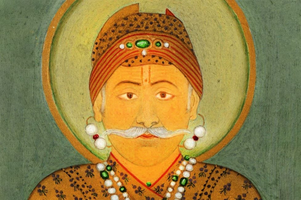 A portrait in opaque watercolor and gold on paper of Emperor Akbar, adorned in a gold outfit with a floral motif and an array of intricate jewelry.