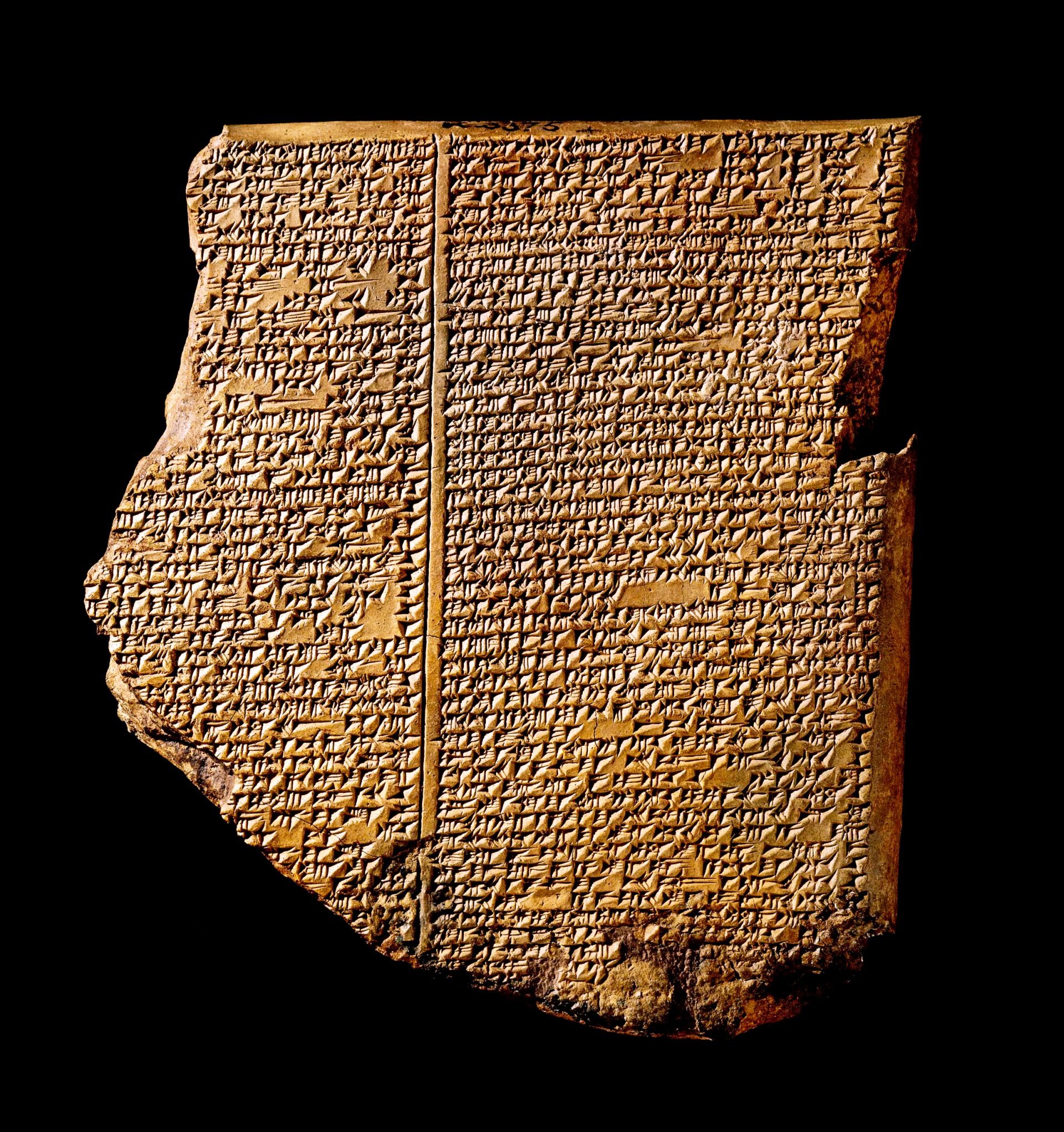 A photo realistic image of a fragment of an ancient clay tablet with cuneiform writing on a black background. The tablet is broken and incomplete, with the top left corner missing. The cuneiform writing is in a grid-like pattern, with each line separated by a horizontal line. The tablet is light brown and has minor chips and cracks.