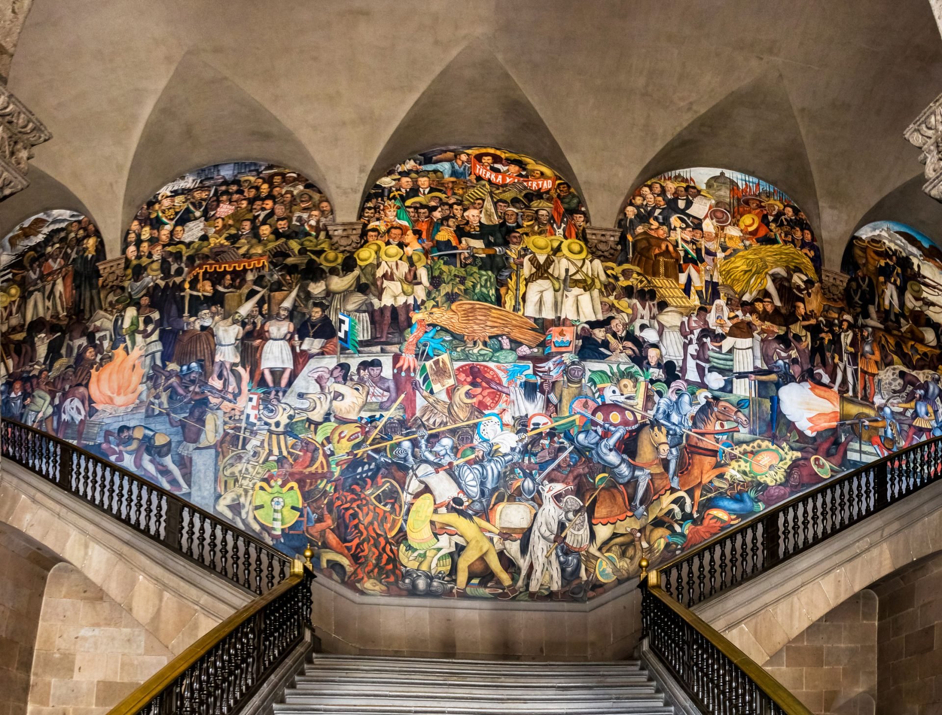 A photograph of a portion of the mural Epopeya del pueblo Mexicano that extends over 276 square meters and covers several centuries of the history of Mexico.