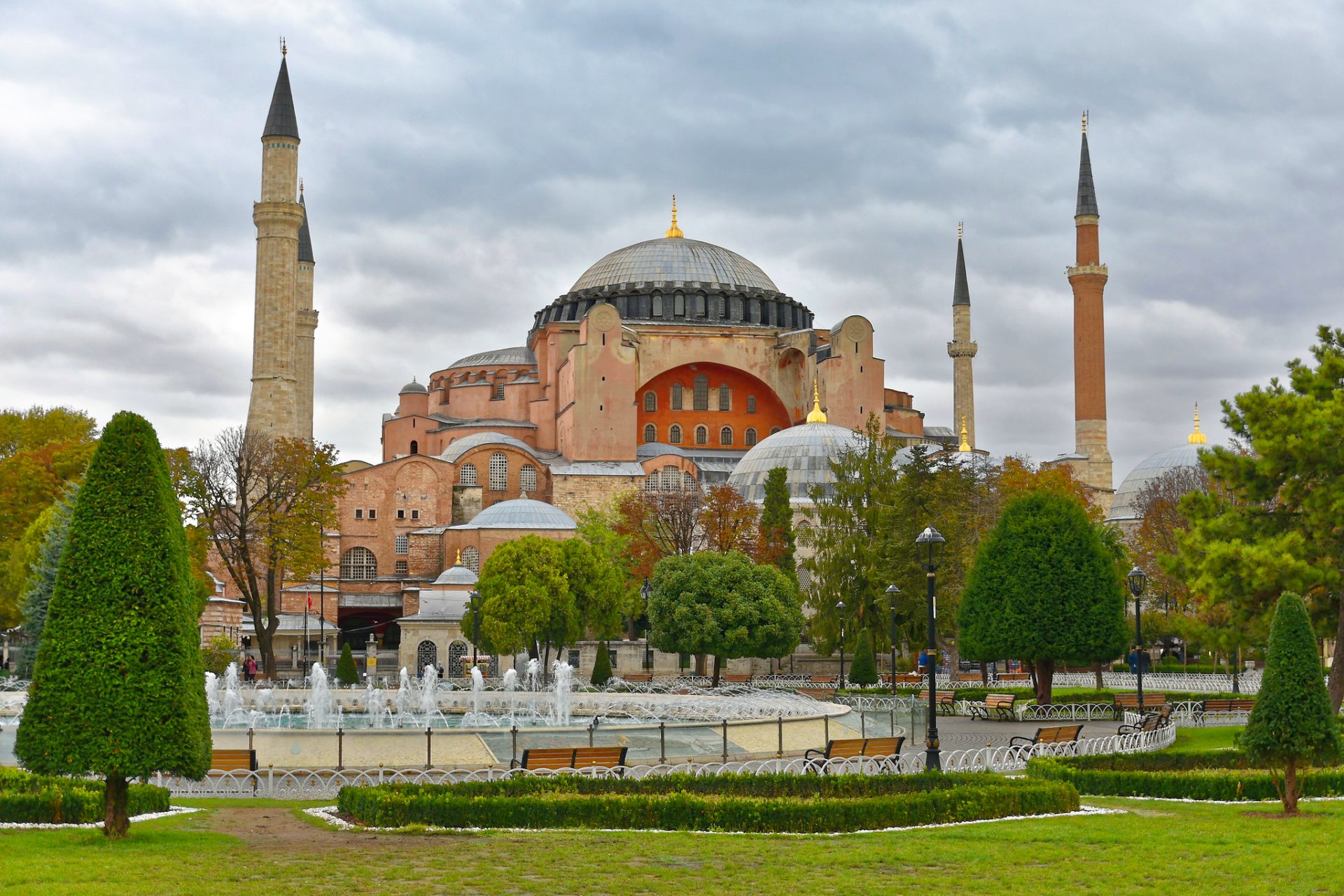 A photo of the Hagia Sophia, a former cathedral, mosque, and museum in Istanbul, Turkey, with a dome and four minarets on a cloudy day.
