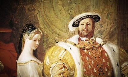 This painting shows a man wearing a large round hat and a gold color fur coat. He is standing next to a woman wearing a white dress. They both appear to be royals. The man has a disapproving look on his face and the woman is looking down.