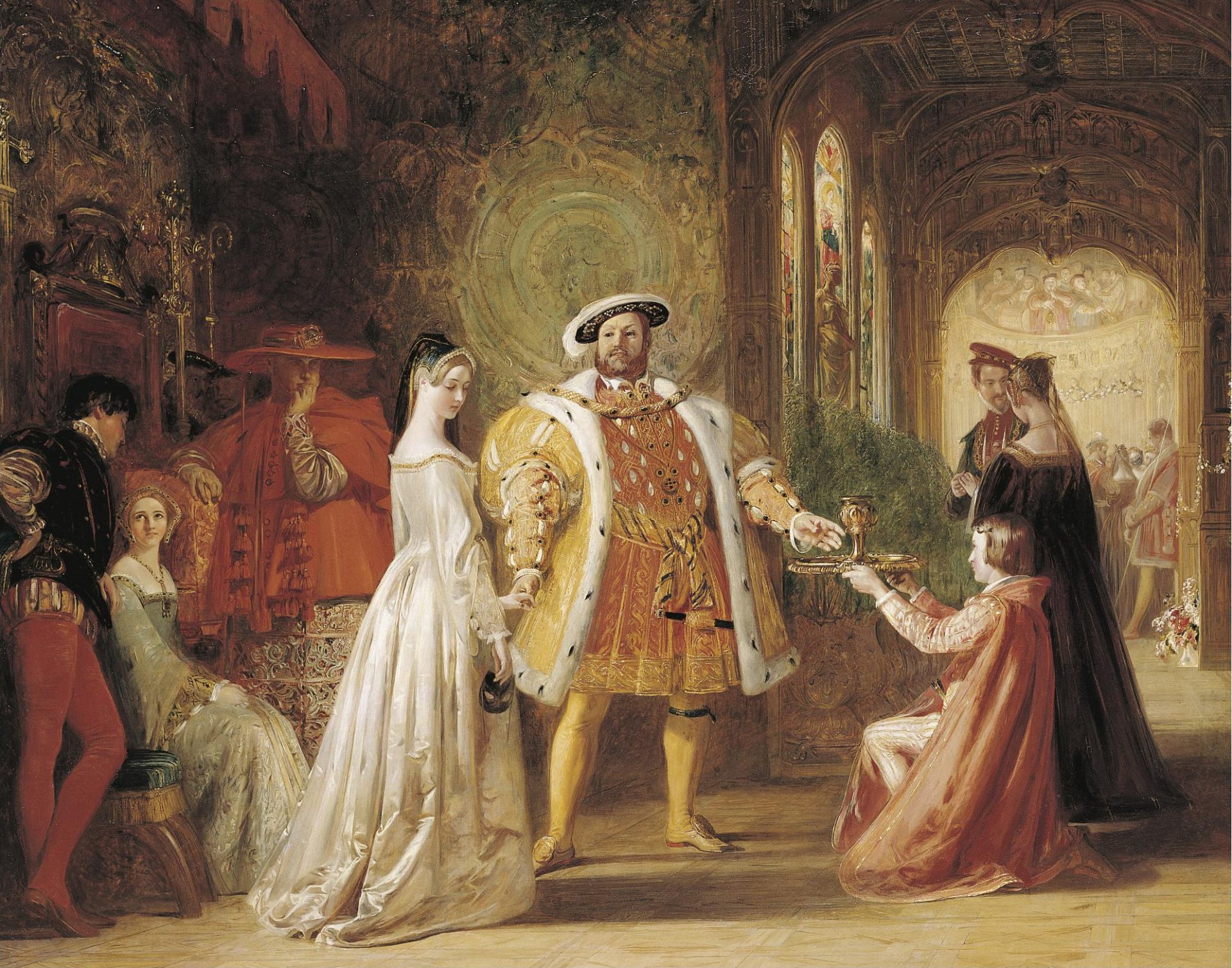 The painting depicts Anne Boleyn and Henry VIII in a room full of people. Anne is wearing a crown on her head and a long white dress with intricate designs. Henry VIII is standing in the center of the room, wearing a fancy fur coat. Several other people are standing around the room.
