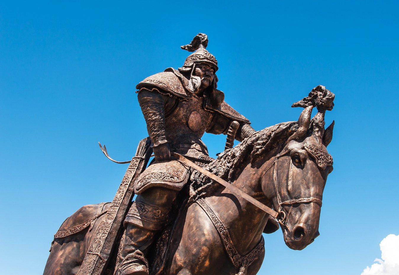 A photo of a bronze statue of a Mongolian general, possibly Jebe, on a horse in the Chinggis Khaan Statue Complex.