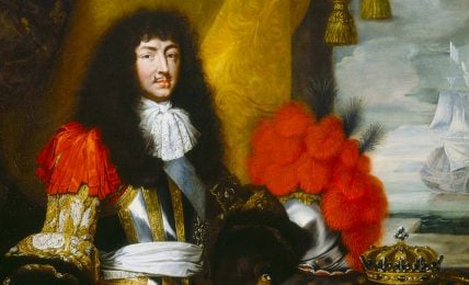 A painting featuring king Louis XIV in a black wig and full ceremonial armor, his crown is lying next to him on a pillow.