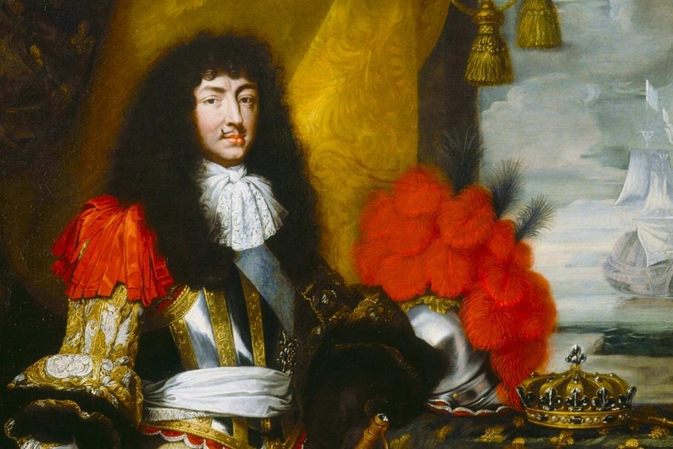 A painting featuring king Louis XIV in a black wig and full ceremonial armor, his crown is lying next to him on a pillow.