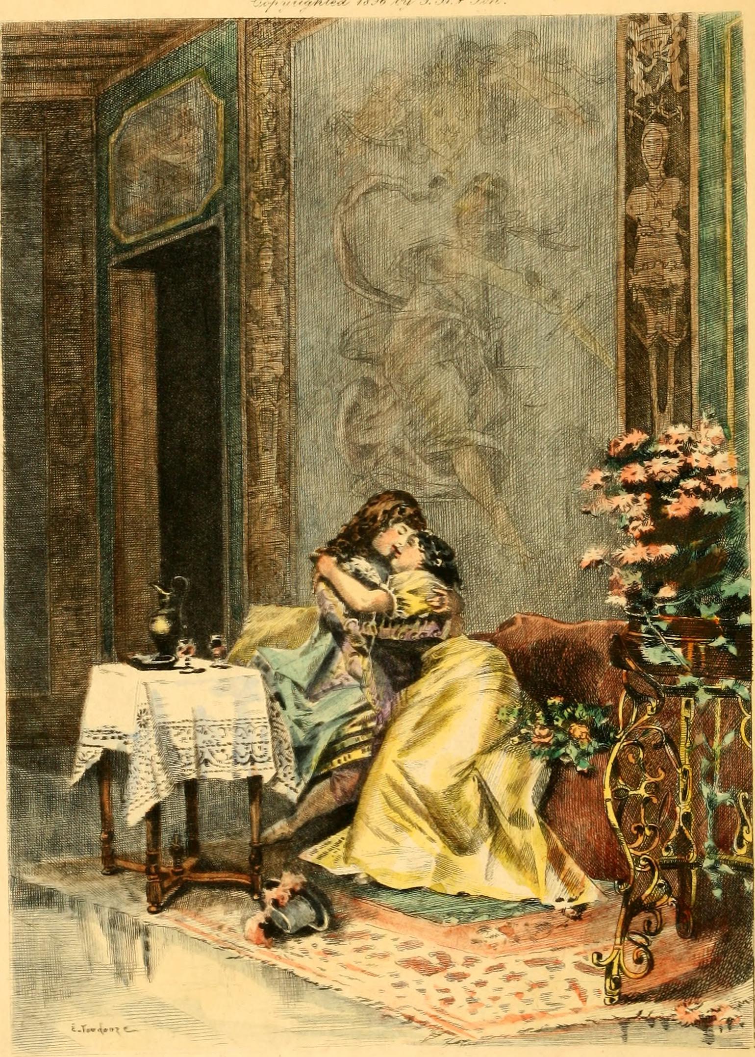 The image shows a woman sitting on a sofa in an elegant-looking room with a large, ornate rug. She is wearing a gray dress. Another woman in gold dress, is in her arms. They seem to be consoling each other.