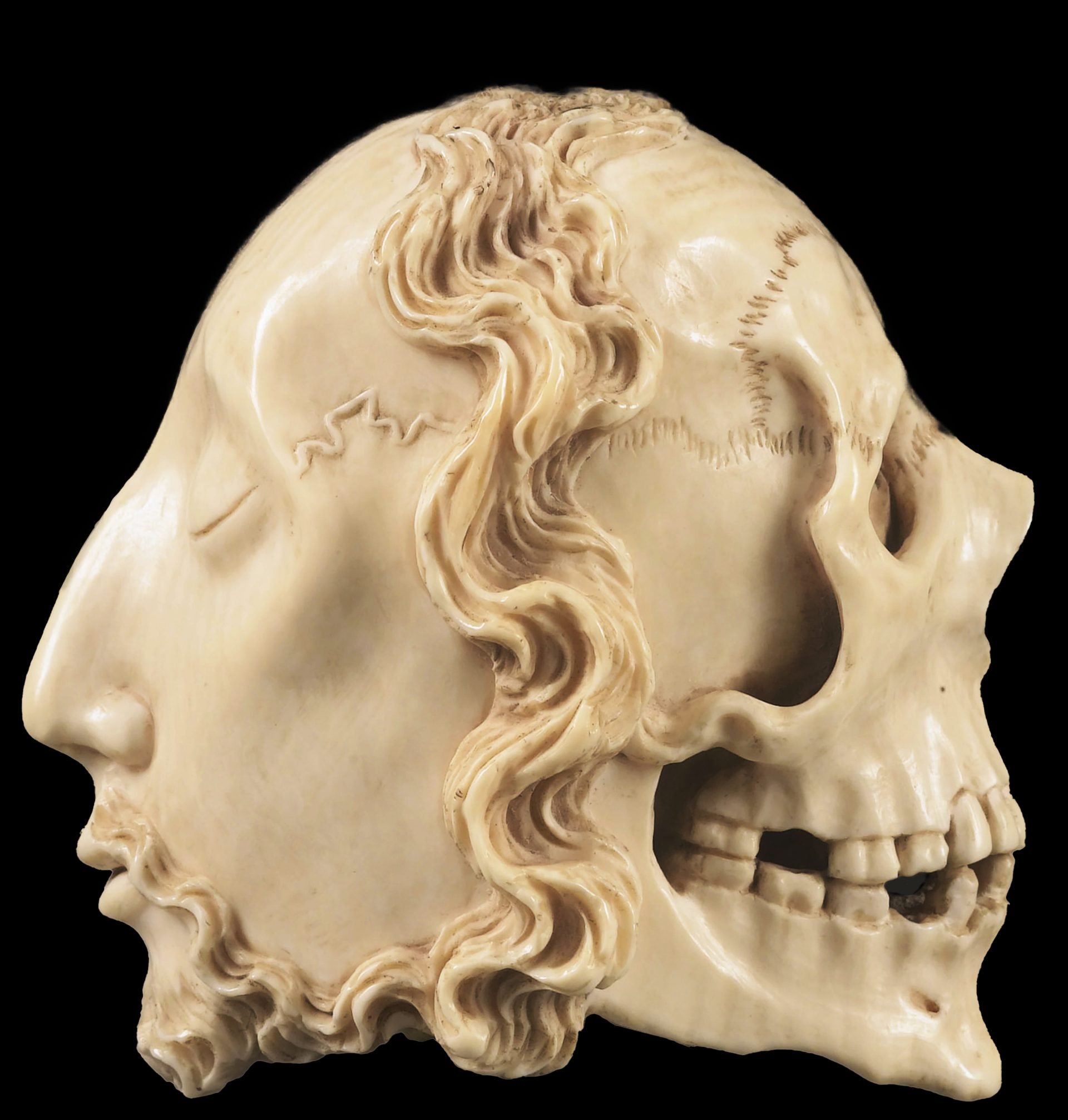 Double-sided Memento Mori features a male face with closed eyes on one side, and a death's skull on the other.