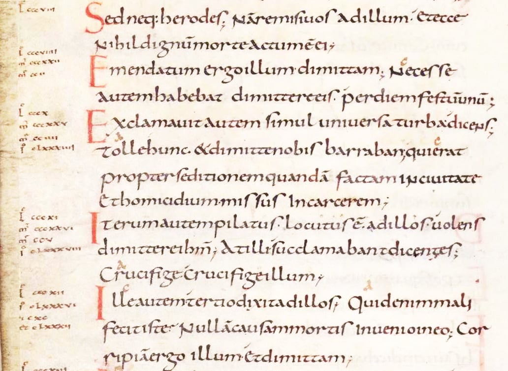 A page from a medieval manuscript written in a Gothic script in black ink. The page is decorated with red and blue initials and line fillers. The text is written in two columns. The text appears to be in Latin. The page is slightly faded and has some stains and discoloration.