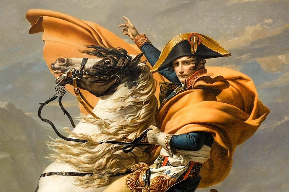 Dramatic painting of Napoleon Bonaparte mounted on a rearing white horse, ascending a rugged alpine landscape. Napoleon, adorned in a vibrant red cape, confidently points upwards while turning to look at the viewer.