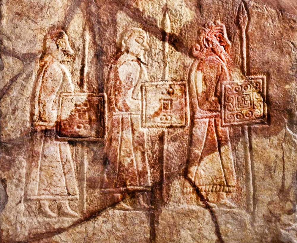 7th or 8th-century Pictish stone slab from Birsay, Orkney, depicting three warriors with styled hair and beards, each armed with spears and detailed shields.