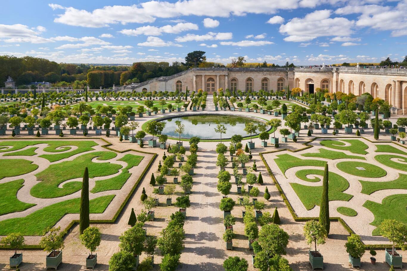 A photograph of the courtyard gardens at Chateau Versailles.