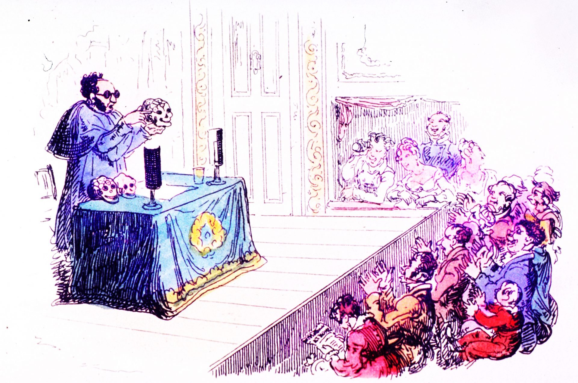 An illustration of a man performing a Phrenological analysis on a skull in front of an excited audience. The man is standing behind a blue table with a black candle and skulls on it.