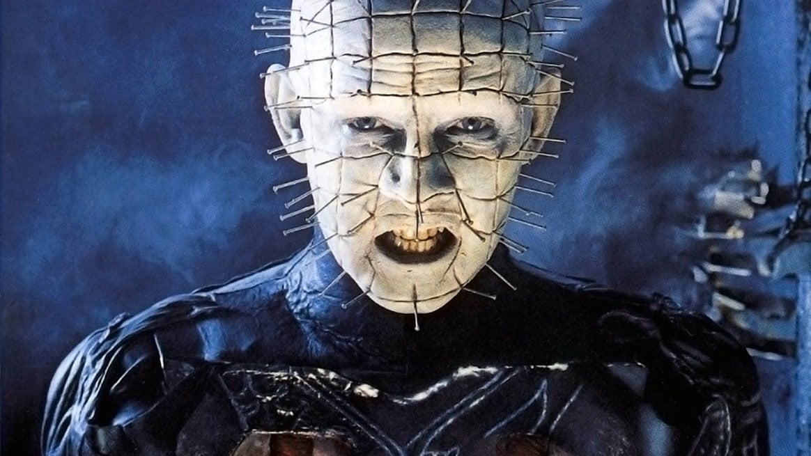 A bald man with his entire head covered in protruding nails, his skin cut into squares.