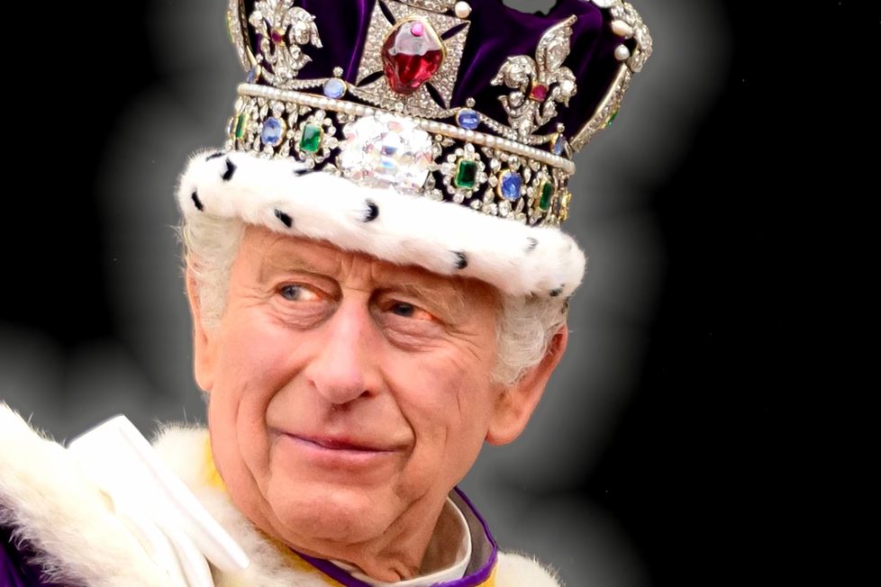 A photograph of King Charles on the day of his coronation, he is wearing an elaborate velvet crown covered in jewels and trimmed with fur.