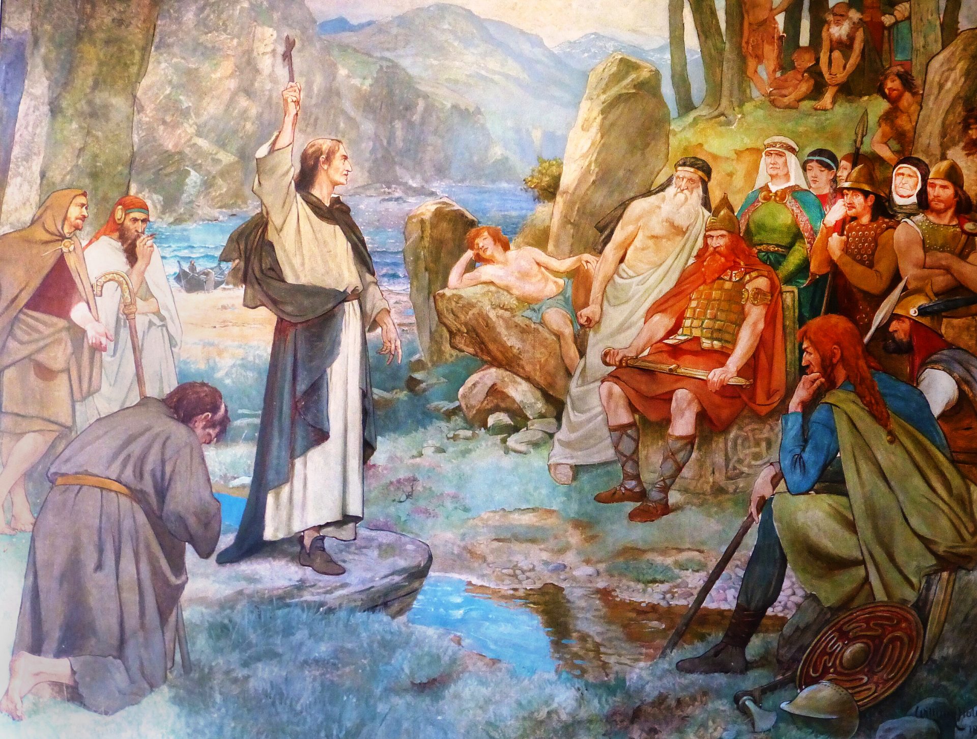 A 19th-century depiction showcasing Saint Columba converting Pictish King Bridei to Christianity. A group of Pictish people in a rocky landscape with a river and mountains in the background. The people are dressed in traditional clothing from the medieval period. The central figure is a man in a white robe holding up a cross, possibly representing Saint Columba. To the left of the central figure, there is a man kneeling in prayer, showing devotion and reverence. To the right of the central figure, there are several people sitting and standing on rocks, observing and listening to him. The background consists of a river and mountains with trees and shrubs, creating a natural and scenic setting. The colors in the painting are predominantly blue, green, and brown, giving a sense of calmness and harmony. The painting has a realistic style, showing details and proportions accurately.
