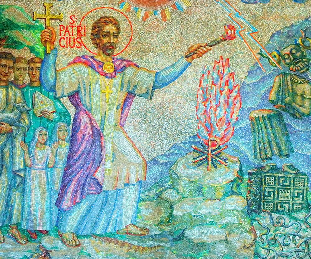 Vibrant mosaic in Christ the King Cathedral, Mullingar, illustrating Saint Patrick lighting the Paschal Fire on the Hill of Slane. The intricate tilework showcases not only this sacred act but also a crumbling druid statue and snakes being driven away, symbolizing the legend of Saint Patrick ridding Ireland of snakes.