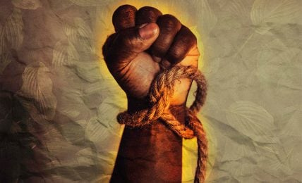A hand holding a rope with a yellow leafy background. The hand is dark-skinned and the rope is frayed, suggesting strength and determination.
