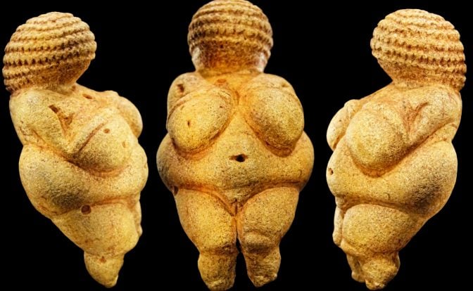 Three images of Venus of Willendorf, each facing a different direction, a light-colored statue of a woman with a large bust and hips and a high hairstyle, on a black surface.