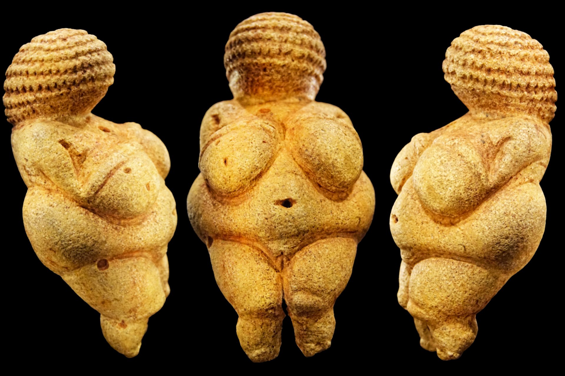 Three images of Venus of Willendorf, each facing a different direction, a light-colored statue of a woman with a large bust and hips and a high hairstyle, on a black surface.