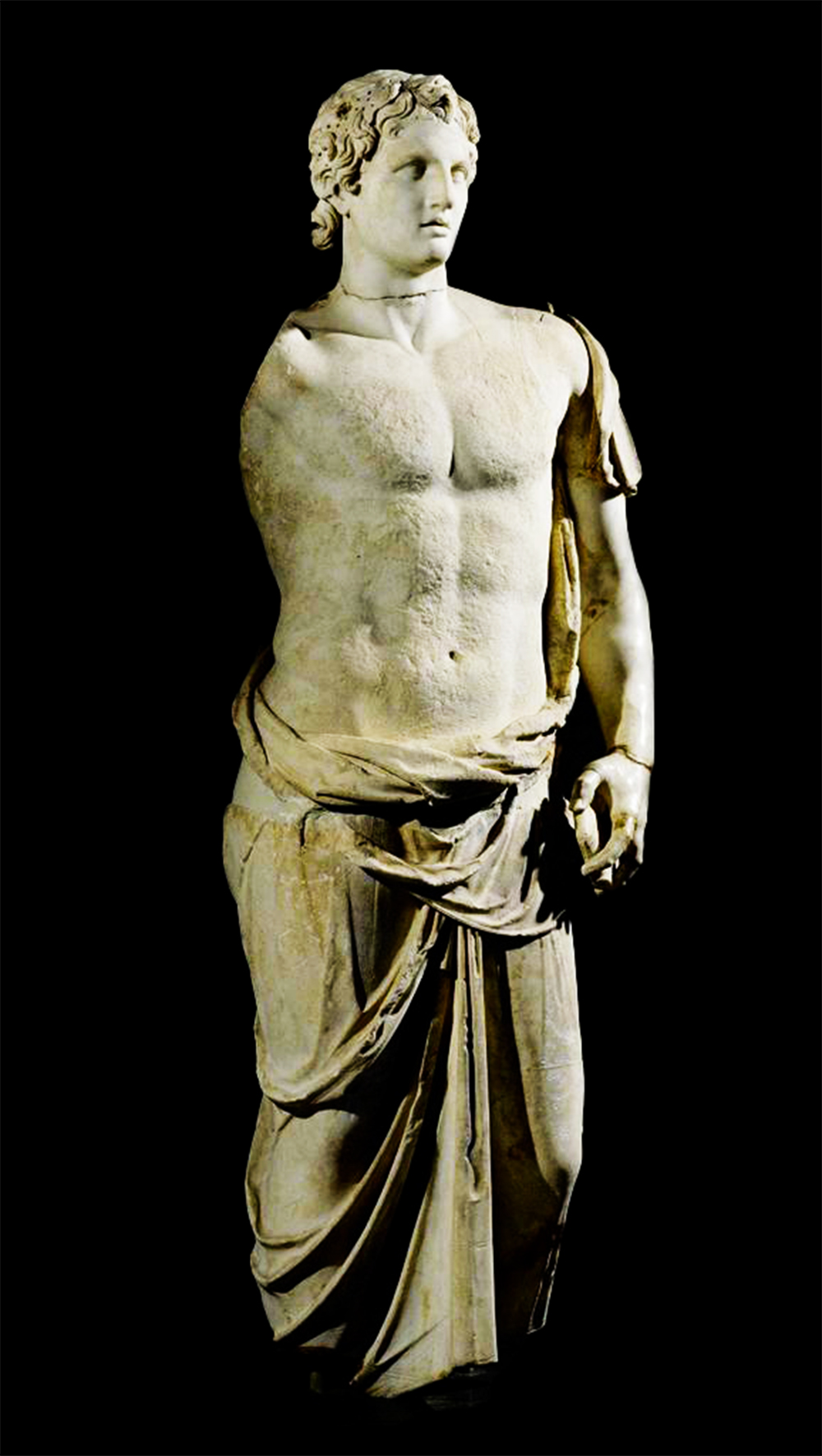 Marble statue of Alexander the Great from the Hellenistic period, draped in a himation. The sculpture captures a detailed representation of his face and curly hair, and is inspired by an original work by Lysippos from the late 4th or 3rd century BCE. The statue's torso is partially exposed, and the himation gracefully wraps around his lower body.