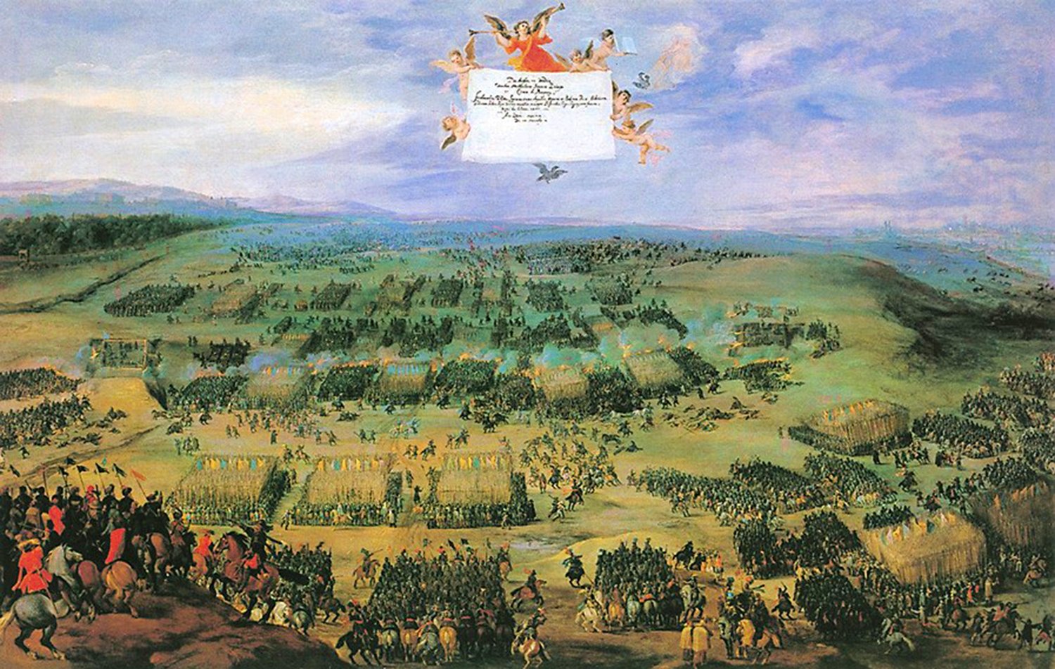 A panoramic painting of the Battle of White Mountain, depicting expansive landscapes with undulating hills. Multiple formations of soldiers, distinguishable by their uniforms and standards, engage in combat across the field. Cavalry units are seen galloping, while infantry hold their ground in tight formations. On the left foreground, commanders on horseback appear to be strategizing. In the sky, a group of cherubic angels holds a white banner containing inscriptions, symbolizing divine intervention or endorsement.