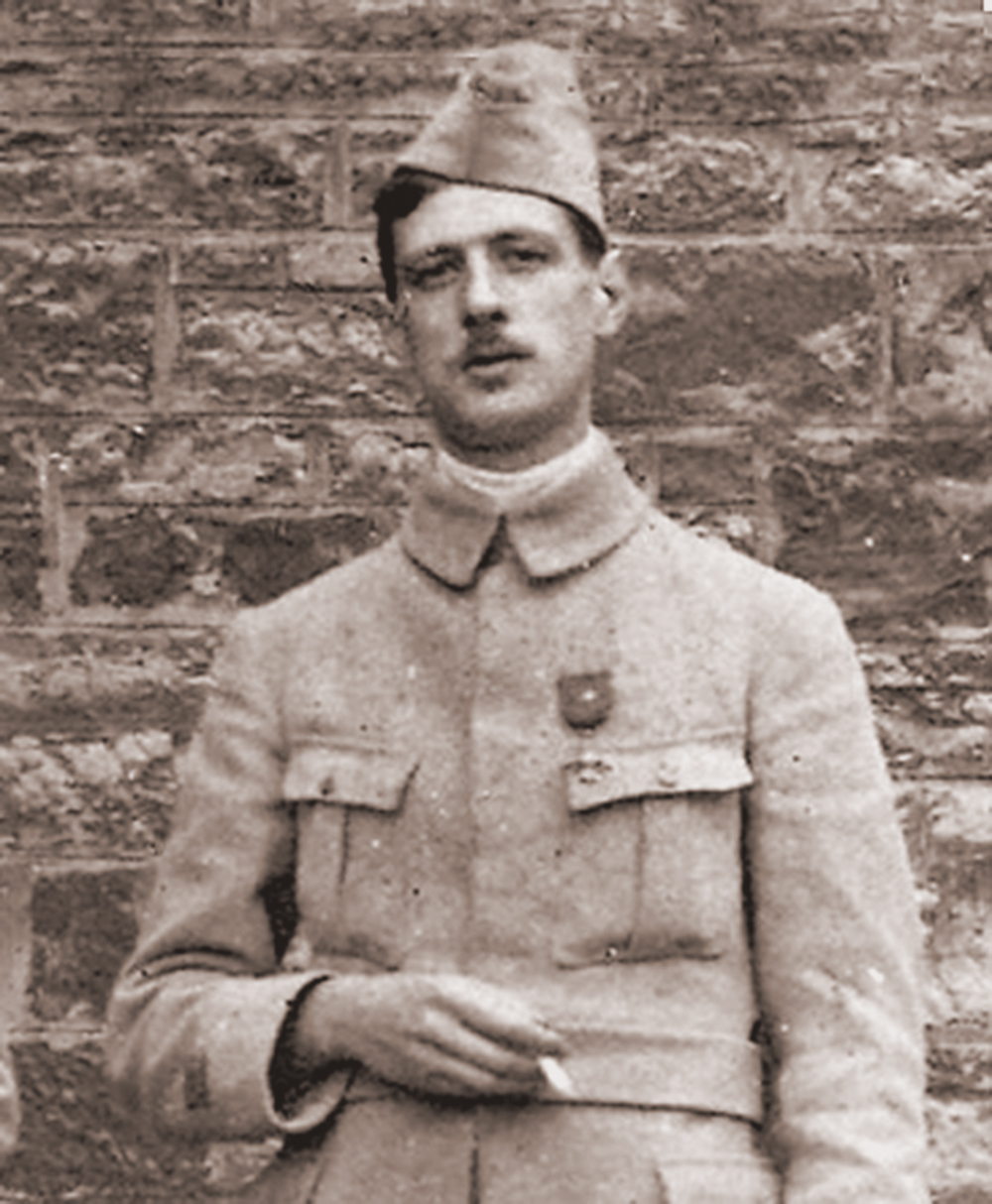 Charles de Gaulle standing against a brick wall during his captivity in Poland in 1916, wearing the Cross of War medal awarded to him in March 1916.