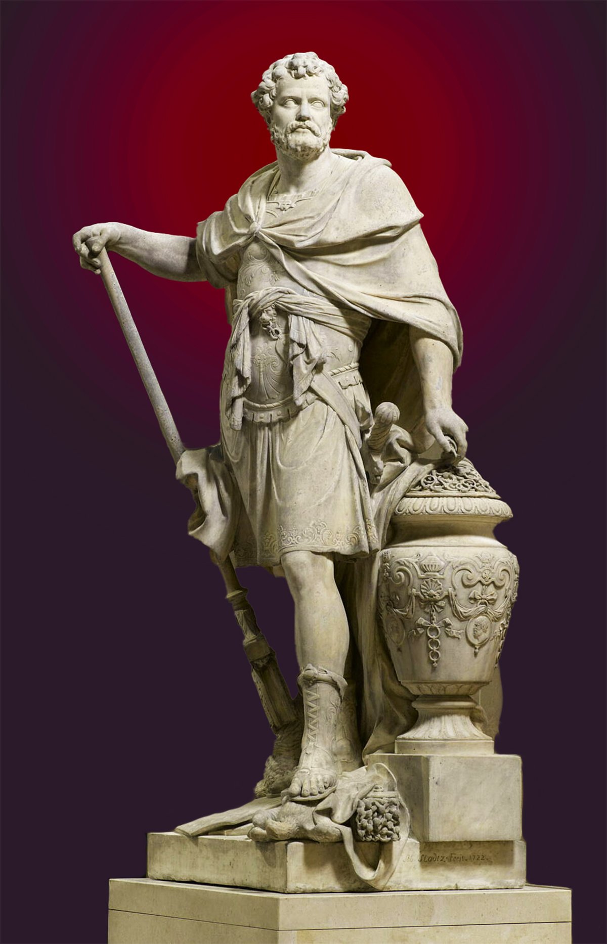 Marble statue of Hannibal Barca by Sebastian Slodtz, dated 1704. Hannibal stands poised, draped in a detailed robe and armor, holding a staff. His expression is determined, with curly hair and a beard. The statue is accentuated by an ornately carved pedestal featuring decorative motifs and an inscription at its base. The richly hued purple background contrasts with the white of the marble, highlighting the statue's details.