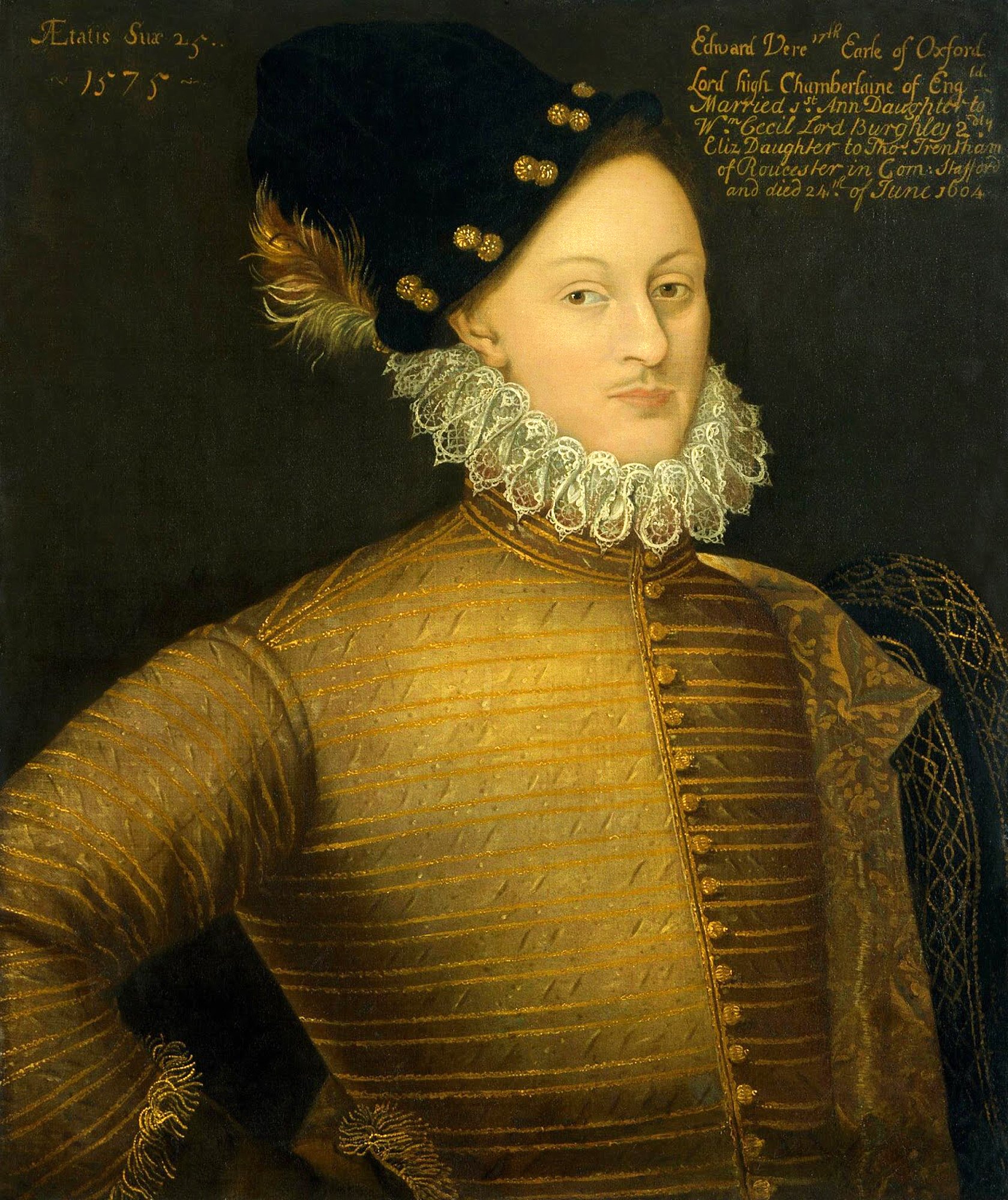 A detailed 17th-century portrait of Edward de Vere, the 17th Earl of Oxford. He appears as a young man, captured in profile with sharp features and a contemplative expression. He dons a lavish gold embroidered doublet with intricate patterns, a lace ruffled collar, and an opulent black hat adorned with golden studs and a feather. The dark background of the painting carries inscriptions detailing his titles and life events, including his role as the Lord Great Chamberlain of England, his marriage, and his death date. The painting exudes a sense of nobility and showcases the fashion and artistry of the era.