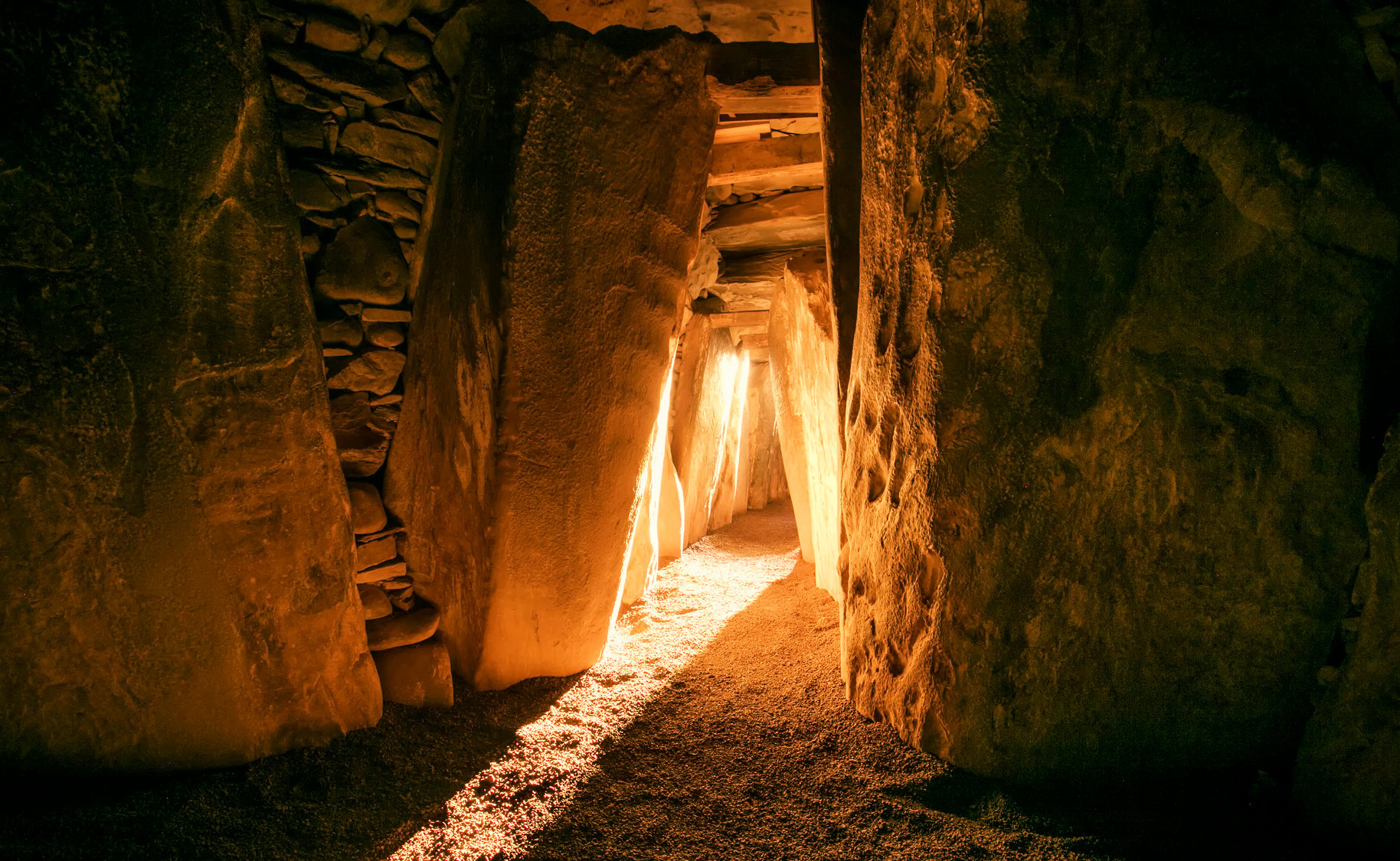 Warm light illuminates the ancient passage of Newgrange, Ireland, during the Winter Solstice, reminiscent of Druid ceremonies.